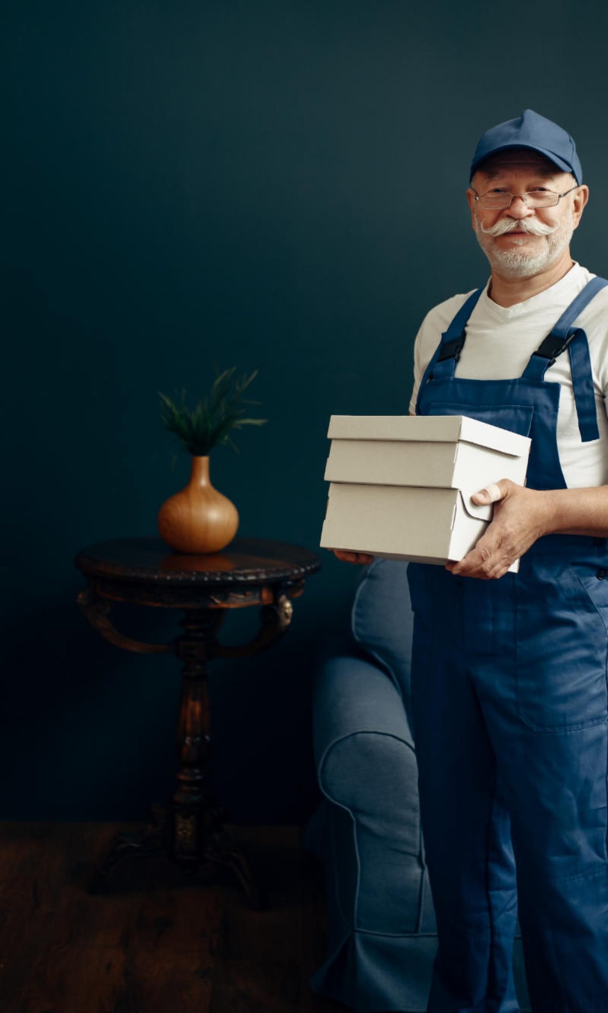elderly-cargo-man-in-uniform-poses-in-home-office-6XAG2PS.jpg